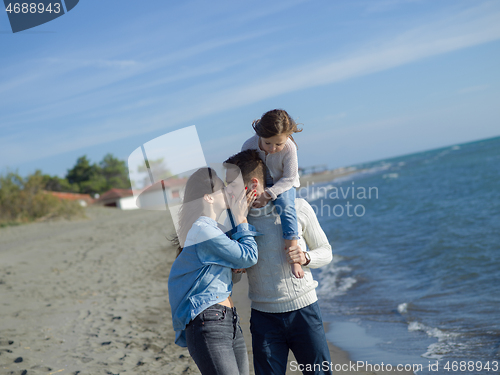 Image of Young happy family enjoying vecation during autumn day