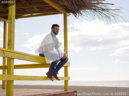 Image of man drinking beer at the beach