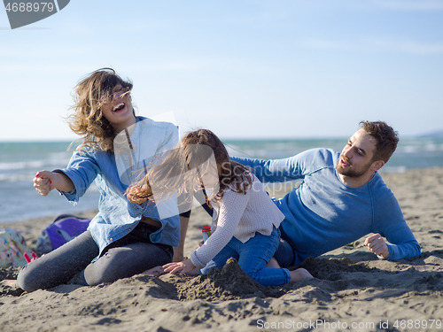 Image of Young happy family enjoying vecation during autumn day