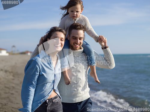 Image of Young happy family enjoying vecation during autumn day