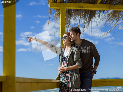 Image of Couple chating and having fun at beach bar