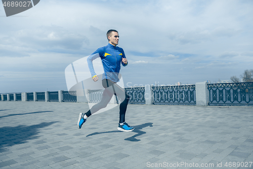 Image of Man running on city background at morning.