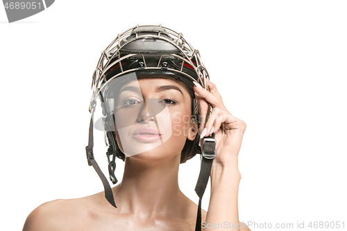 Image of Female hockey player in helmet and mask