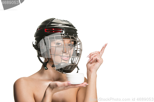 Image of Female hockey player in helmet and mask