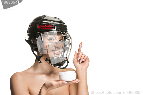 Image of Female hockey player in helmet and mask