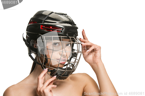 Image of Female hockey player in helmet and mask