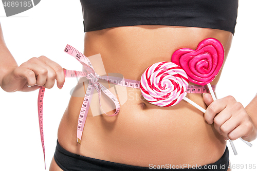 Image of woman abdomen with measuring tape