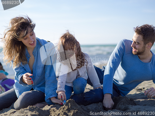 Image of Young happy family enjoying vecation during autumn day