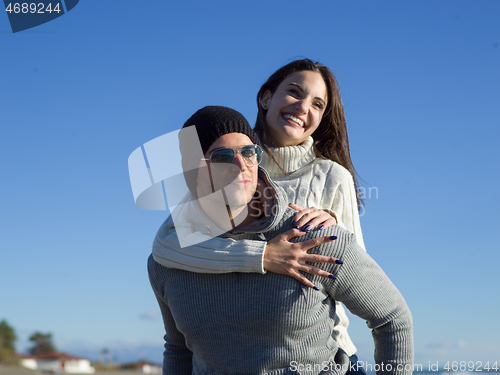 Image of couple having fun at beach during autumn