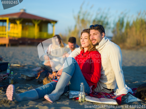 Image of couple on a beach at autumn sunny day