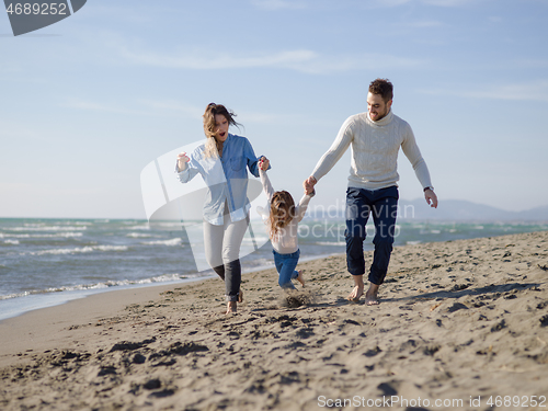 Image of Young happy family enjoying vecation during autumn day