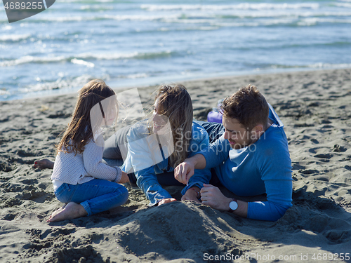 Image of Young happy family enjoying vecation during autumn day