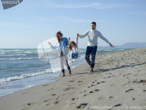 Image of Young happy family enjoying vecation during autumn day