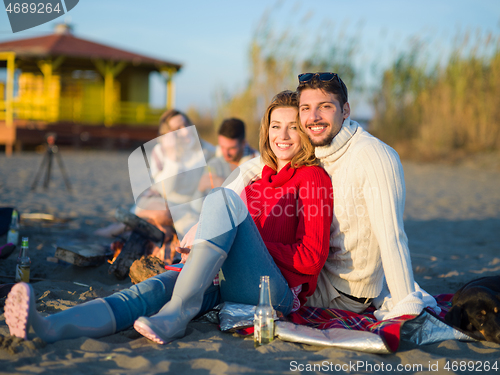 Image of couple on a beach at autumn sunny day