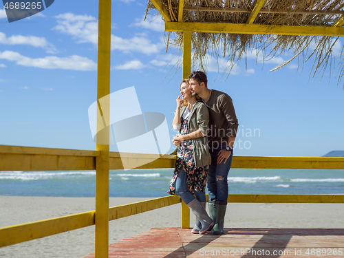 Image of Couple chating and having fun at beach bar