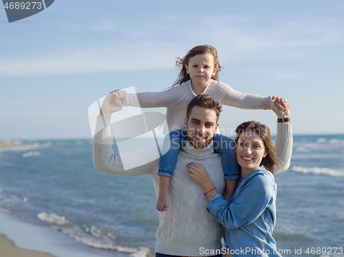 Image of Young happy family enjoying vecation during autumn day