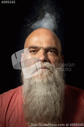 Image of bearded man smoke portrait