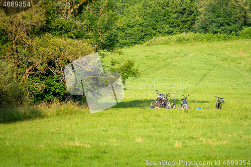 Image of A few bicycles in the meadow