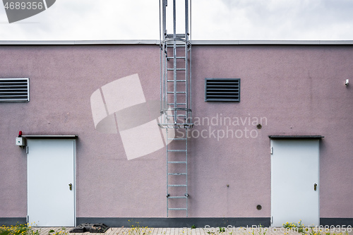 Image of wall with doors and ladder