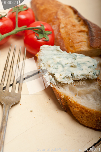 Image of fresh blue cheese spread ove french baguette