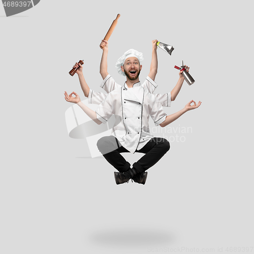 Image of Cooker, chef, baker in uniform multitask like shiva isolated on gray studio background