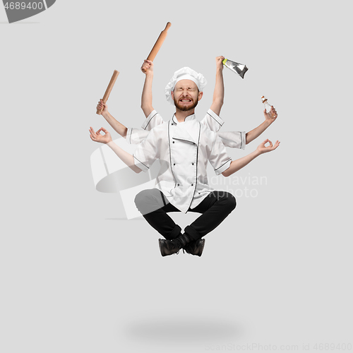 Image of Cooker, chef, baker in uniform multitask like shiva isolated on gray studio background