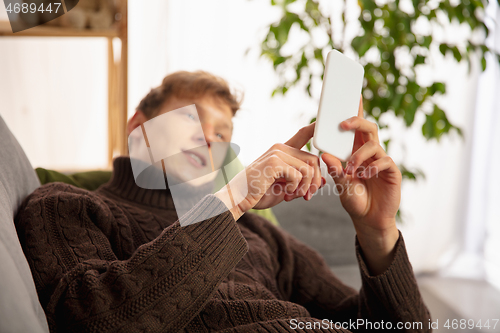 Image of Man reading message, greetings for New Year and Christmas 2021 from friends or family with his cellphone