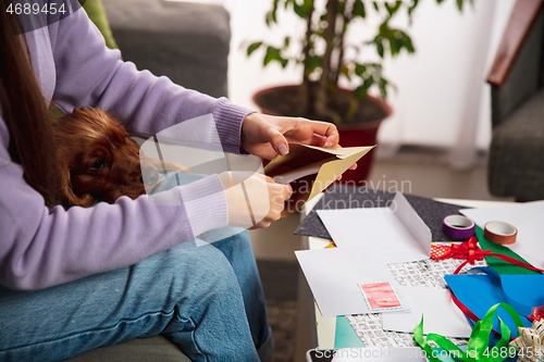 Image of Woman opening, recieving greeting card for New Year and Christmas 2021 from friends or family