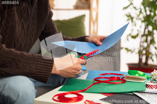 Image of Man making greeting card for New Year and Christmas 2021 for friends or family, scrap booking, DIY