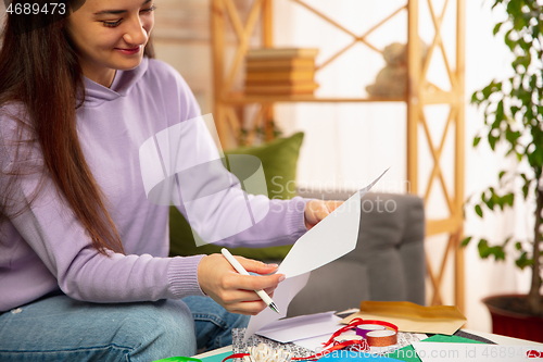 Image of Woman writing letter, greeting card for New Year and Christmas 2021 for friends or family