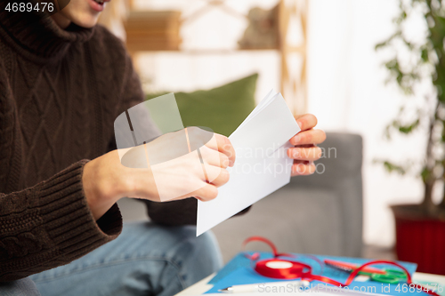 Image of Man opening, recieving greeting card for New Year and Christmas 2021 from friends or family