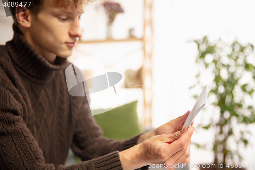 Image of Man opening, recieving greeting card for New Year and Christmas 2021 from friends or family