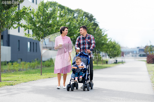 Image of family with baby in stroller and coffee in city