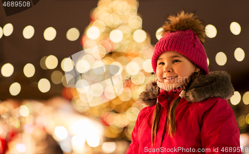 Image of happy little girl at christmas market in winter