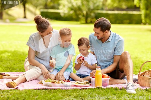 Image of happy family having picnic at summer park