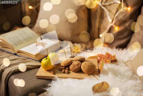 Image of lemons, book, almond and oatmeal cookies on sofa