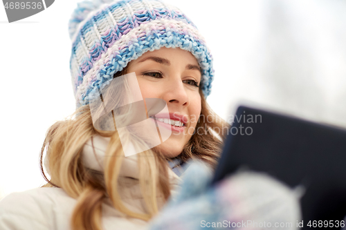 Image of woman with tablet computer outdoors in winter