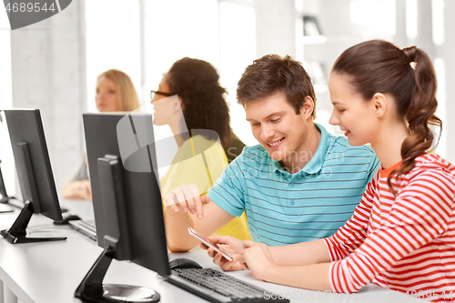 Image of high school students with smartphone and computer