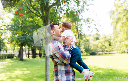 Image of happy father with little son in summer park