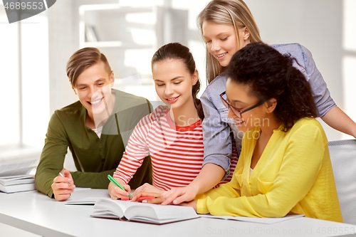 Image of high school students with books and notebooks