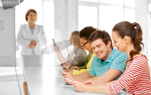 Image of high school students with tablet computers