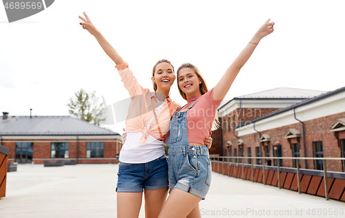 Image of teenage girls or friends on city roof top