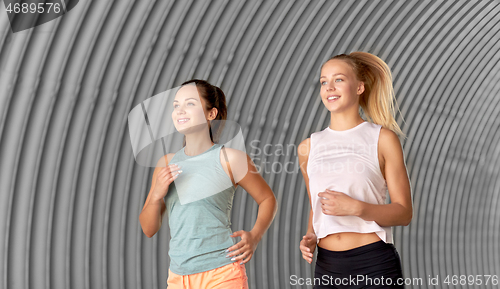 Image of young women or female friends running outdoors