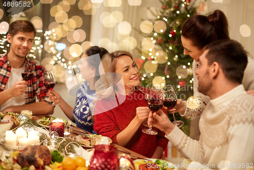 Image of friends celebrating christmas and drinking wine