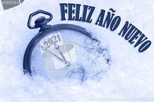 Image of 2021 greeting card, Happy New Year 2021, in Spanish language, Feliz ano nuevo text, countdown to midnight