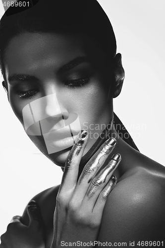 Image of girl with golden paint on fingers