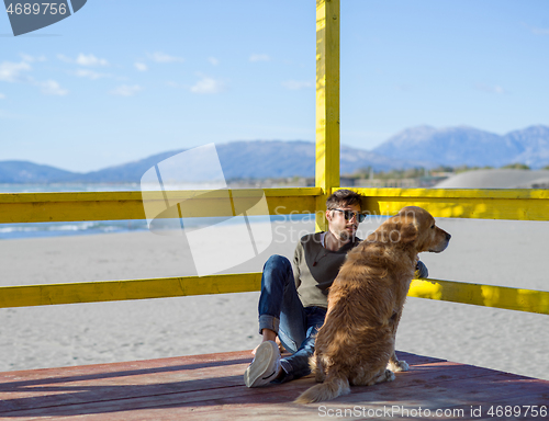 Image of man with dog enjoying free time on the beach