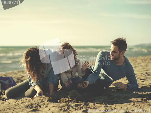 Image of Young family enjoying vecation during autumn day