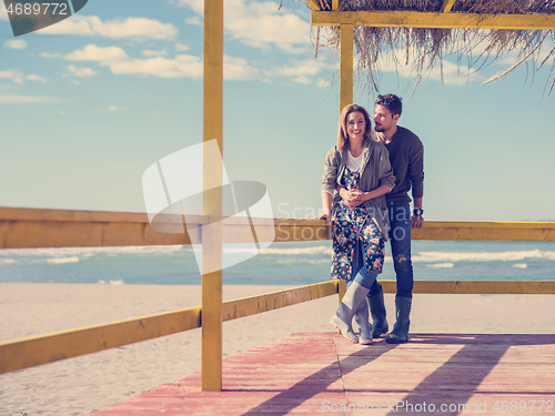 Image of Couple chating and having fun at beach bar