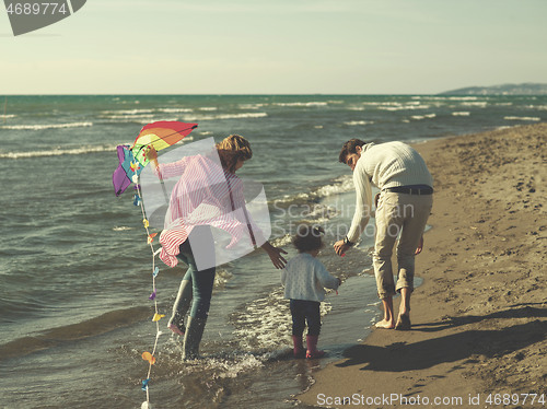 Image of happy family enjoying vecation during autumn day